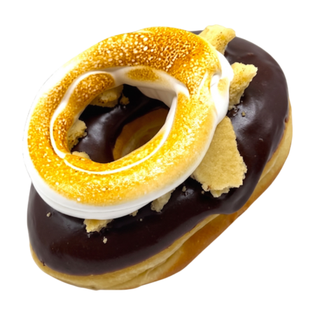 a donut dipped in a chocolate ganache topped with shortbread cookie and torched meringue