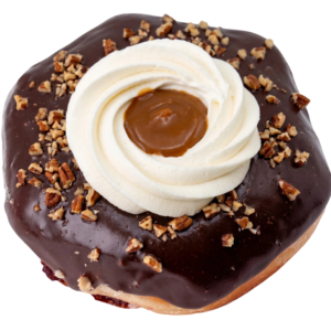 chocolate turtle pie donut dipped in a chocolate and topped with whipped cream, caramel and pecan
