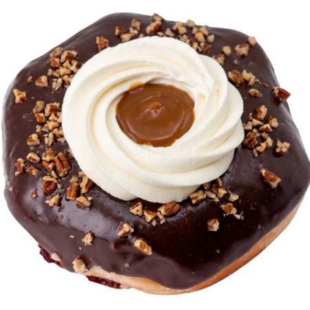 chocolate turtle pie donut dipped in a chocolate and topped with whipped cream, caramel and pecan